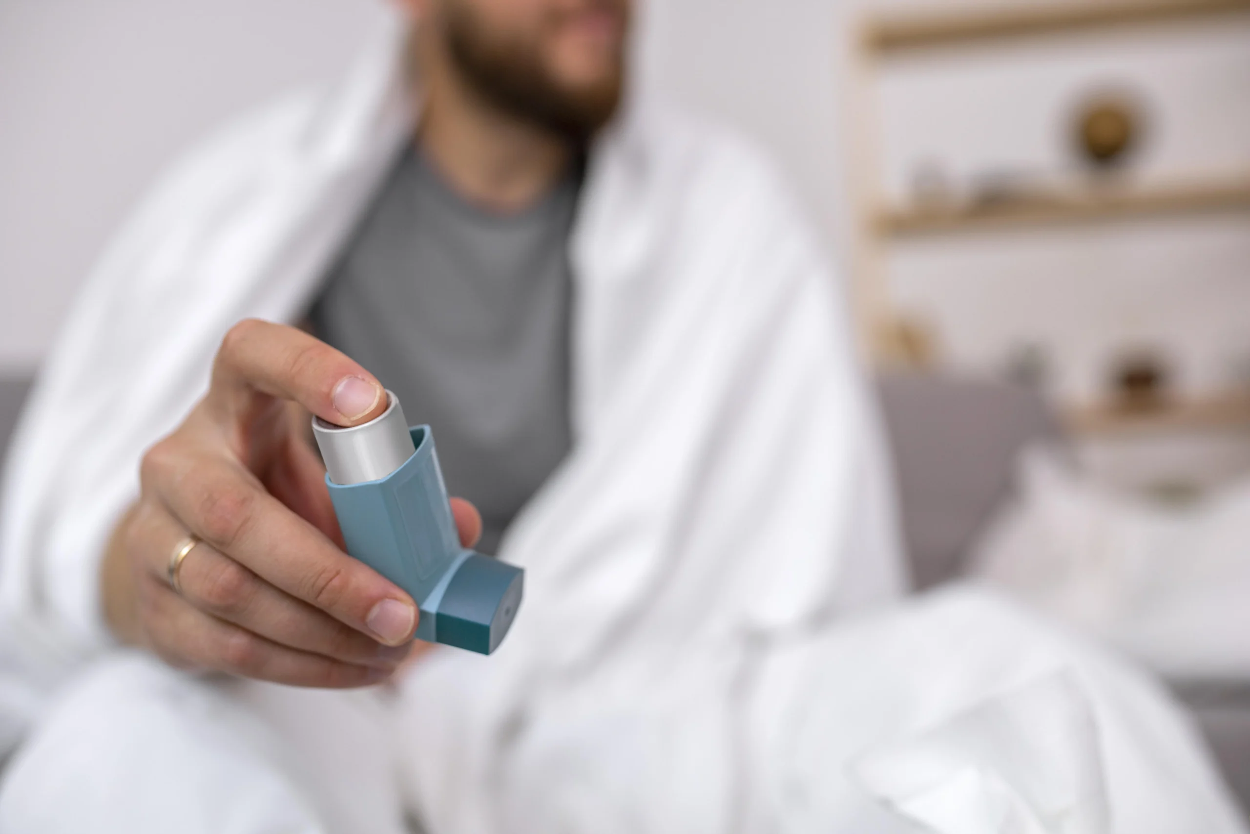 Man holding an asthma inhaler