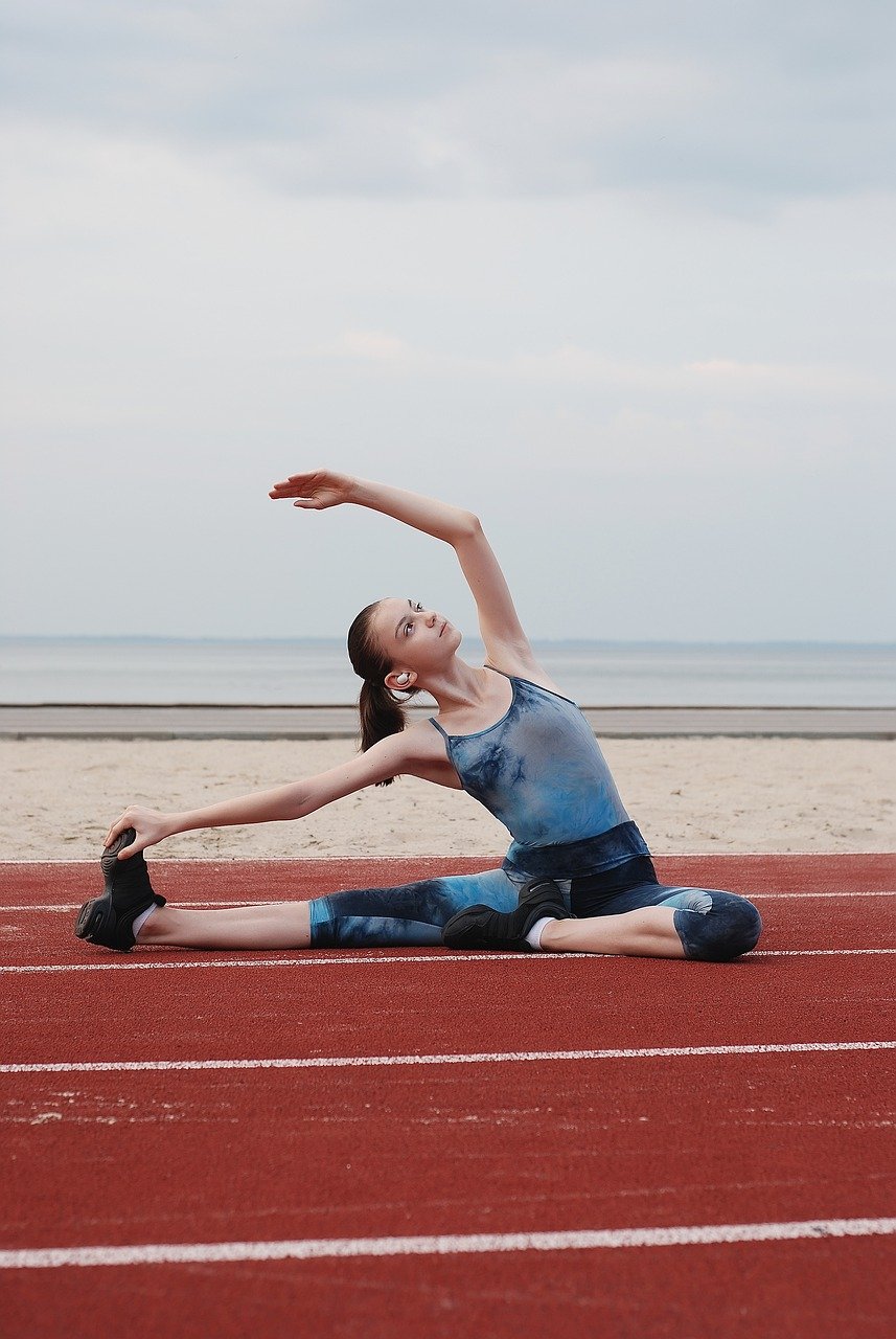 Female stretching on running track