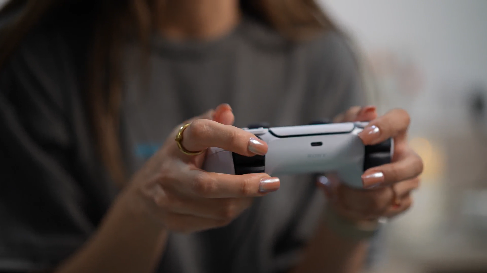 Female volunteer holding a Playstation controller during her clinical trial